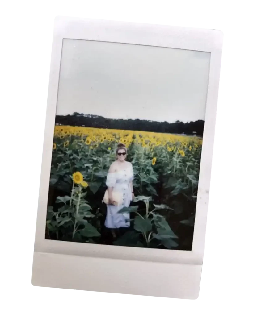 Polaroid of Iliana Rocha with sunflowers