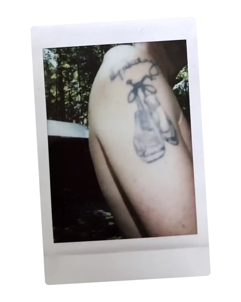 Polaroid of a tattooed arm